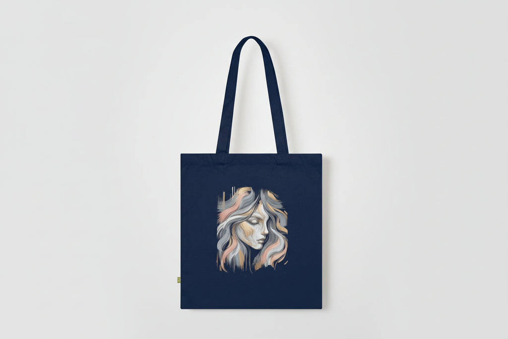 Navy tote bag with a stylized face design on a white background