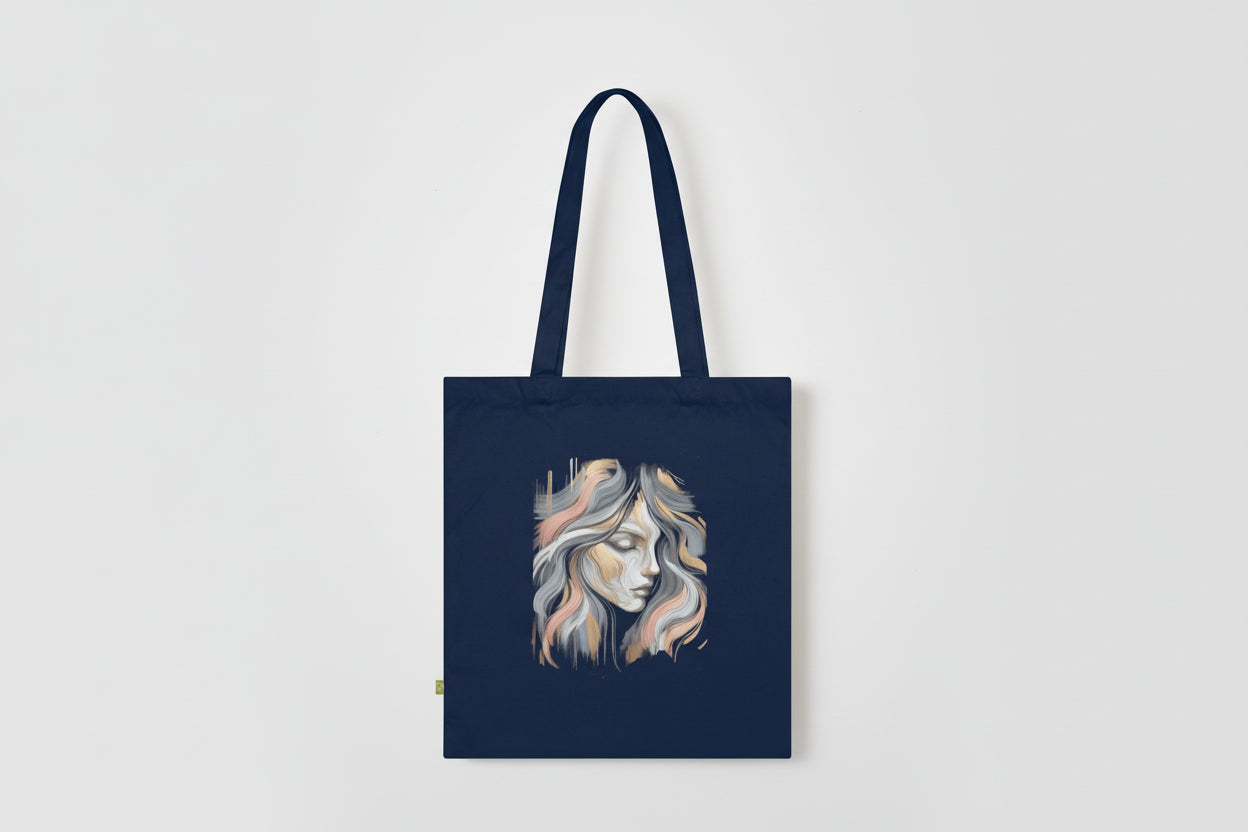 Navy tote bag with a stylized face design on a white background