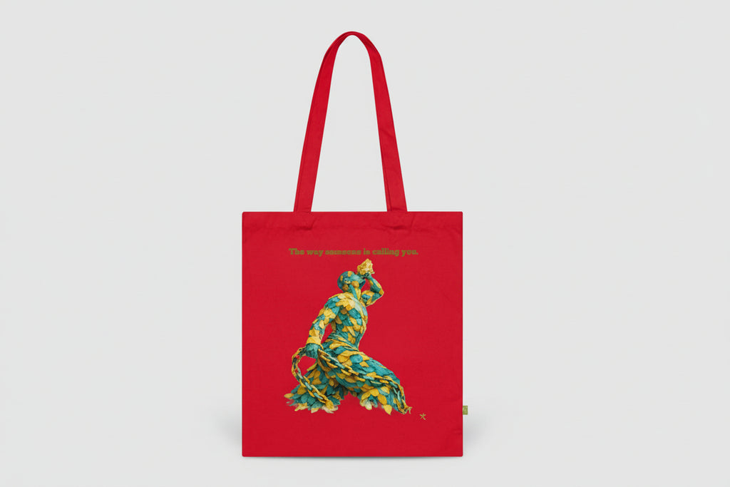 Red tote bag with a colorful bear design and text on a white background