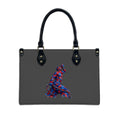 Black handbag with a colorful abstract design on a white background