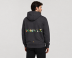 Man wearing a dark gray hoodie with colorful text on the back against a light gray background