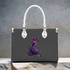 Black handbag with a colorful abstract design on a textured surface