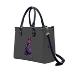 Gray handbag with black handles and strap, featuring a colorful design on a white background